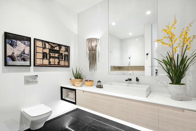 bathroom featuring tile patterned flooring, vanity, and toilet