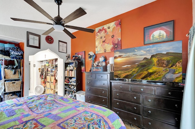 bedroom featuring a closet, ceiling fan, and lofted ceiling