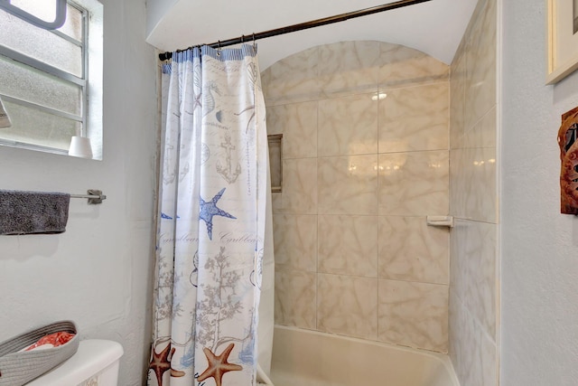 bathroom featuring shower / tub combo with curtain