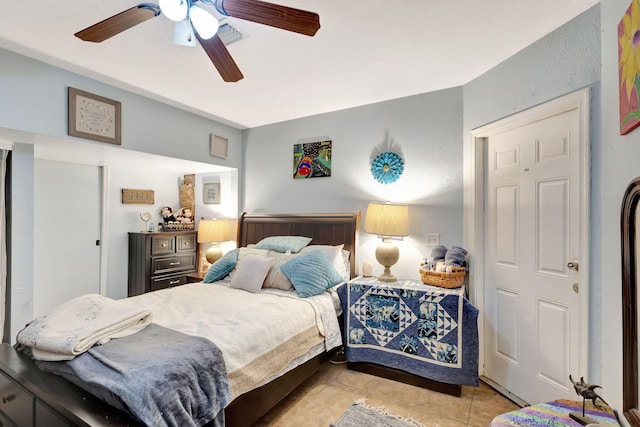 tiled bedroom with ceiling fan