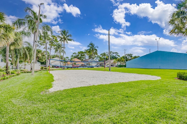 view of community featuring a lawn and volleyball court