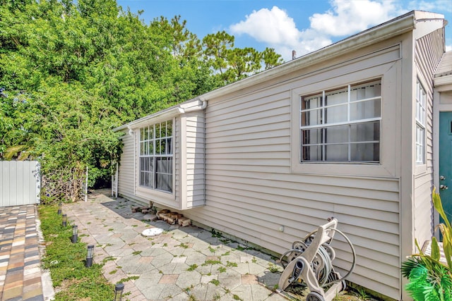 view of side of property with a patio area