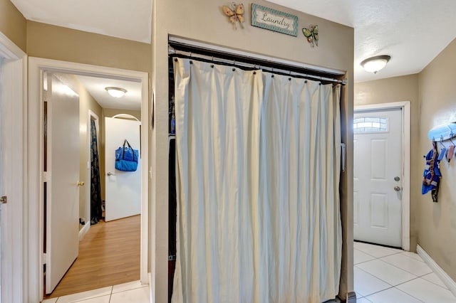 bathroom featuring tile patterned floors and a textured ceiling