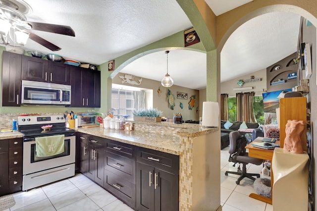 kitchen featuring light tile patterned floors, kitchen peninsula, light stone counters, and appliances with stainless steel finishes