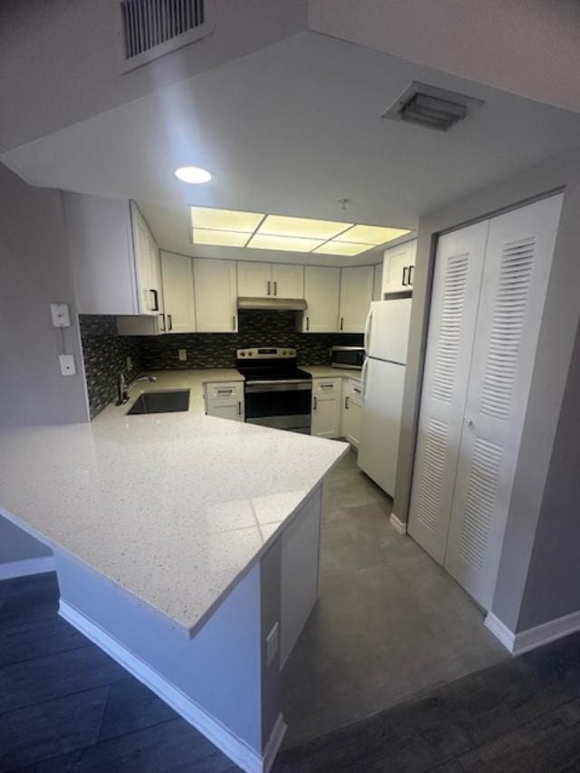 kitchen with kitchen peninsula, white cabinets, and appliances with stainless steel finishes