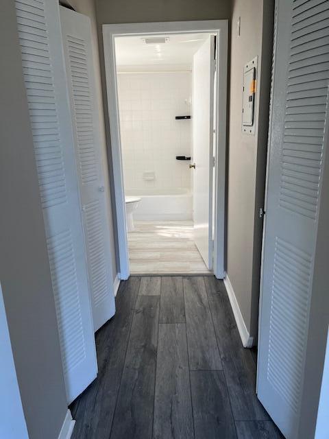 hallway with dark hardwood / wood-style floors