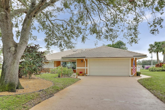 ranch-style home with a front yard and a garage