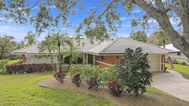 view of front of house with a garage and a front lawn