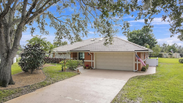 view of front of home with a garage and a front lawn