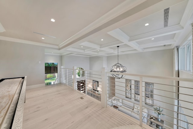 hallway with coffered ceiling, crown molding, light hardwood / wood-style floors, beam ceiling, and a chandelier