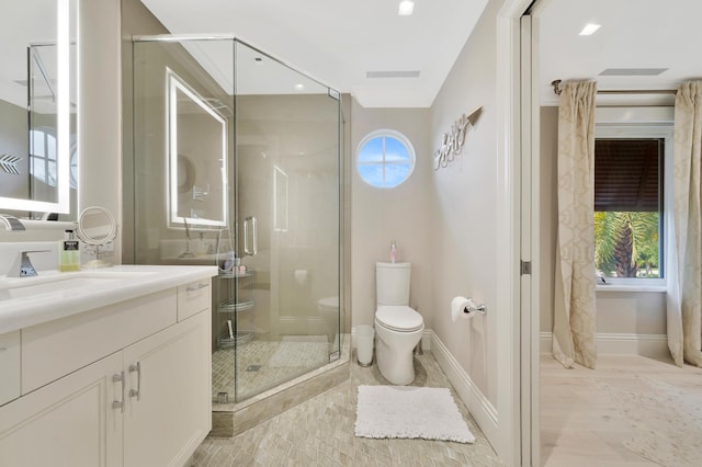 bathroom with vanity, toilet, and walk in shower