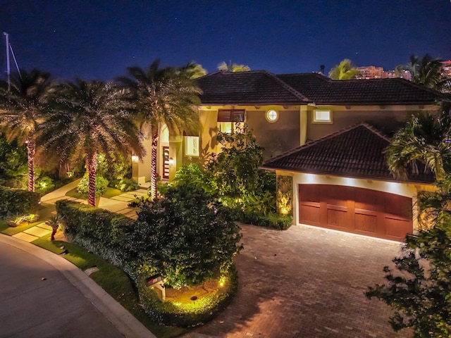 mediterranean / spanish-style house with a garage