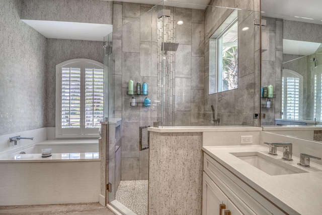 bathroom featuring vanity and separate shower and tub