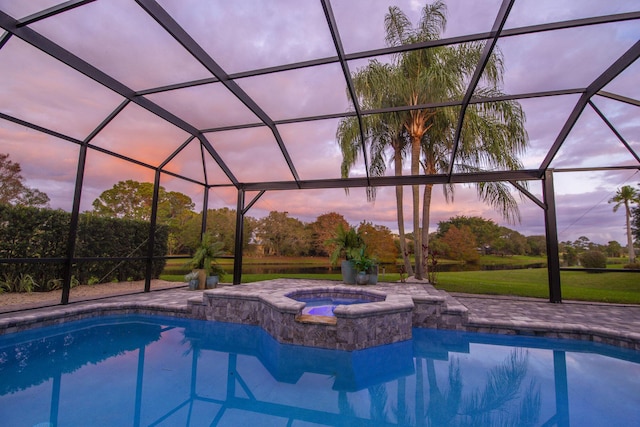 pool featuring a lanai, a patio, and an in ground hot tub