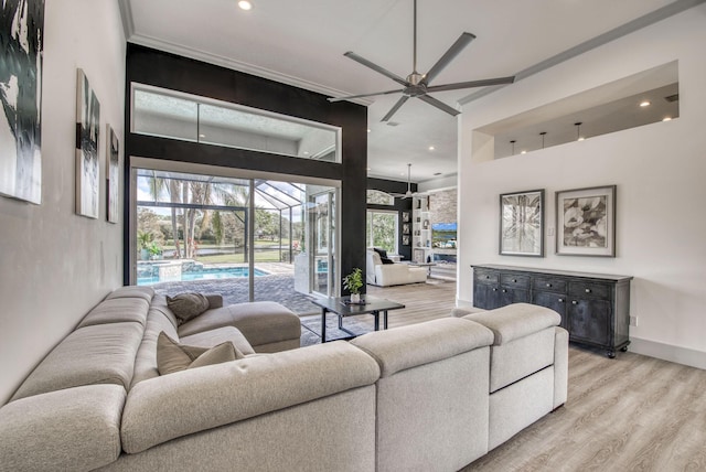 living room featuring ceiling fan and light hardwood / wood-style flooring