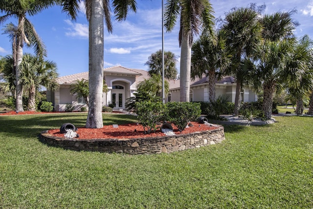 mediterranean / spanish house with a front yard