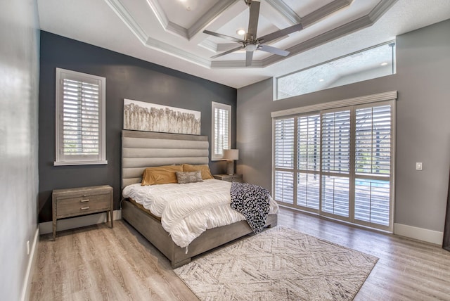 bedroom with multiple windows, coffered ceiling, and crown molding