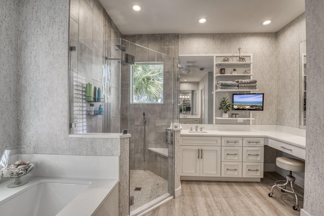 bathroom featuring independent shower and bath, vanity, and hardwood / wood-style floors