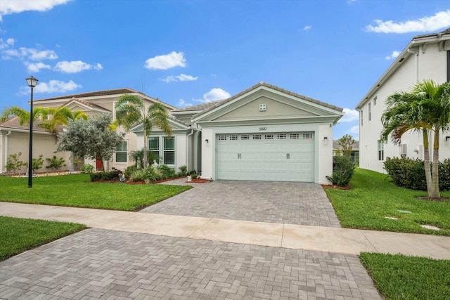 view of front of house with a garage and a front lawn