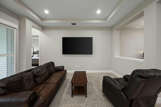 living room featuring a tray ceiling