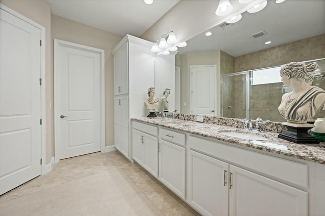 bathroom with tile patterned floors, vanity, and an enclosed shower