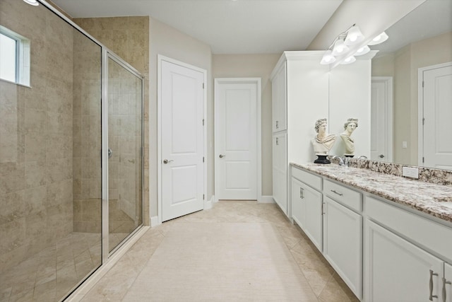 bathroom featuring tile patterned flooring, vanity, and walk in shower