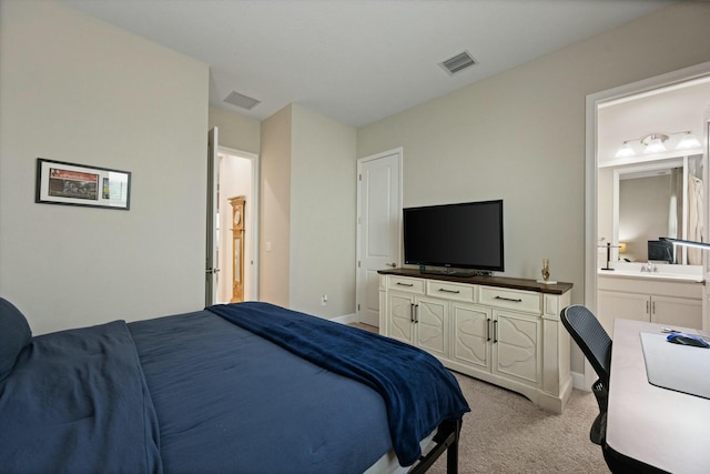 carpeted bedroom featuring ensuite bath