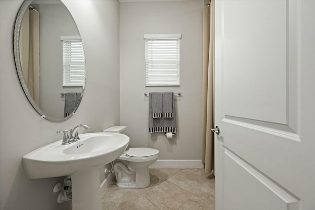 bathroom featuring tile patterned floors and toilet