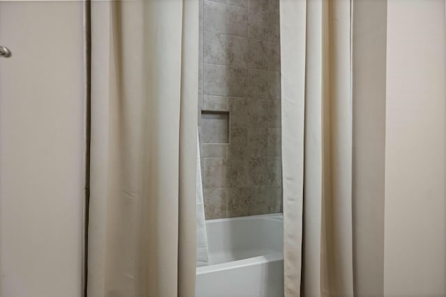 bathroom with shower / tub combo with curtain