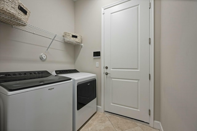 laundry area featuring light tile patterned floors and separate washer and dryer