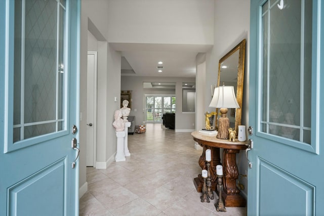 entryway with light tile patterned floors