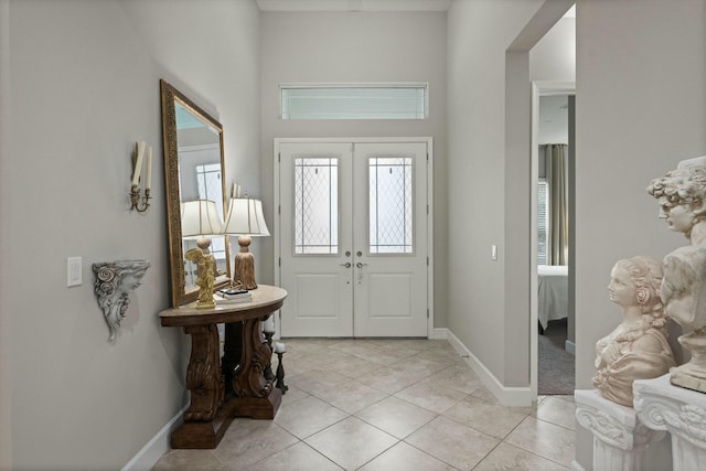 entrance foyer with light tile patterned flooring and french doors