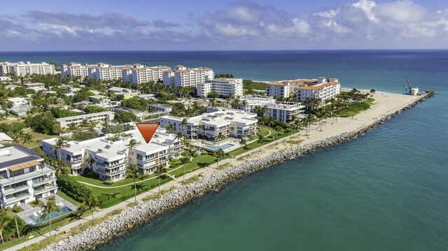 drone / aerial view featuring a water view and a view of the beach