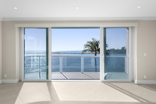 tiled empty room with a water view and crown molding