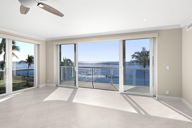 empty room featuring ceiling fan, a water view, light tile patterned floors, and ornamental molding