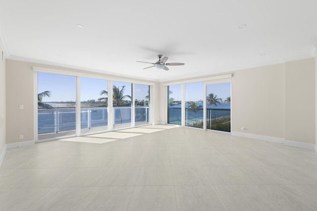 spare room with light tile patterned floors, a water view, ceiling fan, and crown molding