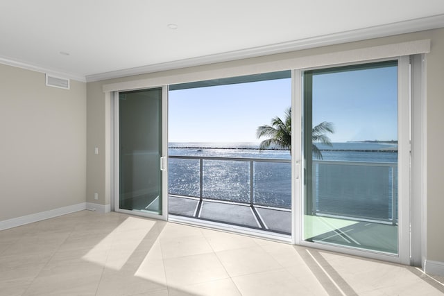 tiled spare room with a water view, plenty of natural light, and ornamental molding