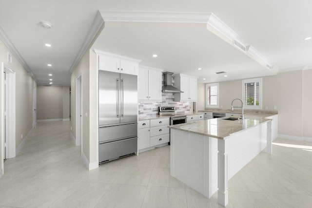 kitchen with white cabinets, appliances with stainless steel finishes, light stone counters, and ornamental molding