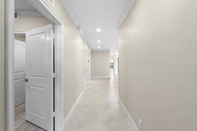 hall featuring light tile patterned floors and ornamental molding