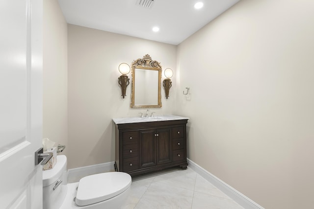 bathroom featuring tile patterned flooring, vanity, and toilet