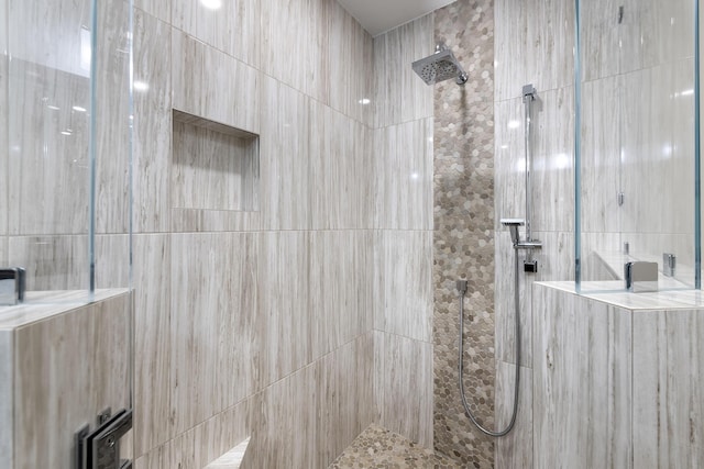 bathroom with a tile shower