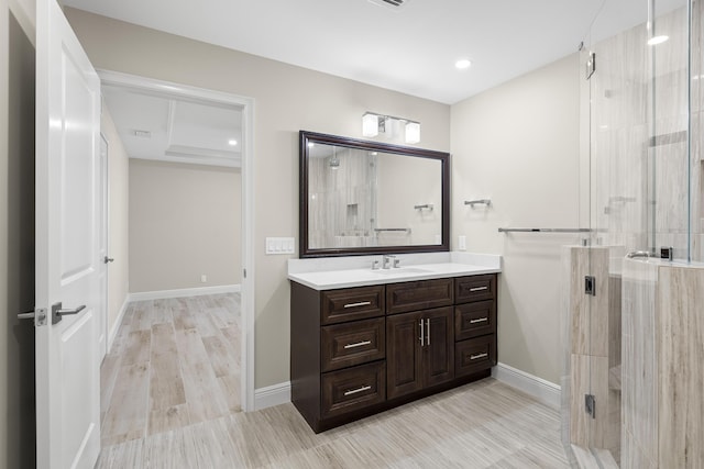 bathroom featuring a shower with shower door, wood-type flooring, and vanity