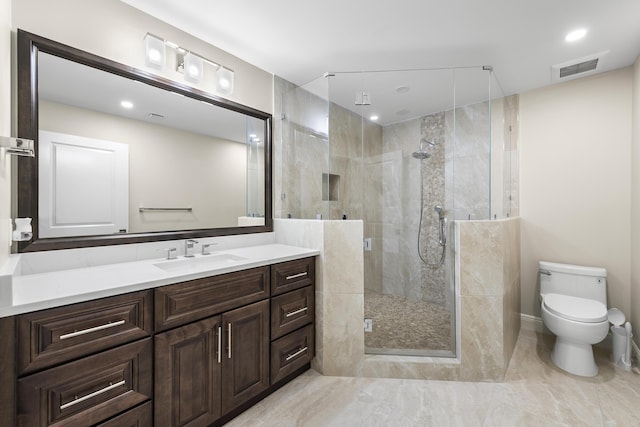 bathroom featuring vanity, toilet, and walk in shower