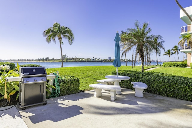 view of patio featuring grilling area and a water view