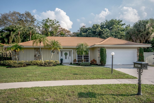 ranch-style home with a front yard and a garage