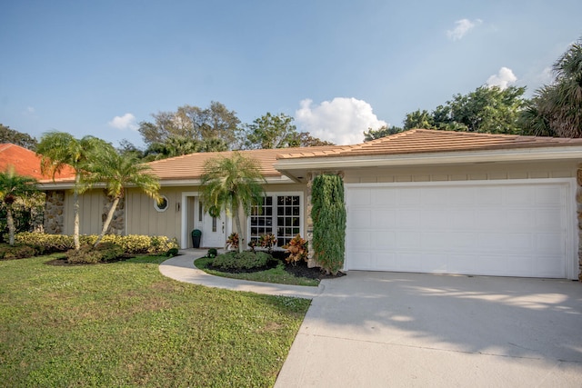 ranch-style house with a front yard and a garage