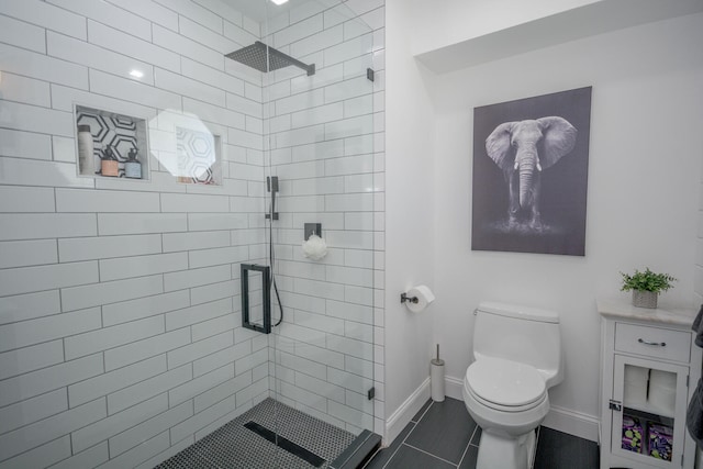 bathroom featuring tile patterned flooring, toilet, and an enclosed shower