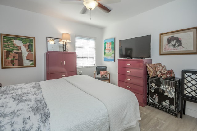 bedroom with a ceiling fan and wood finished floors