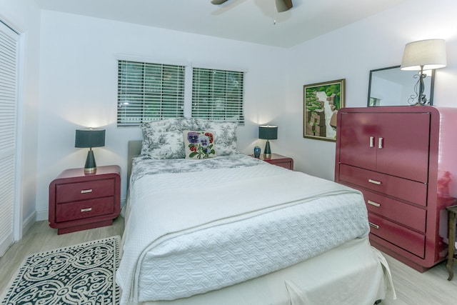 bedroom with a ceiling fan, baseboards, and wood finished floors