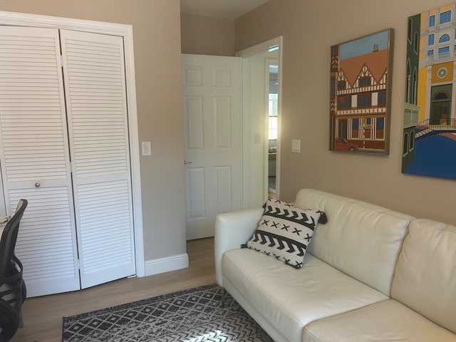 interior space with wood finished floors and baseboards
